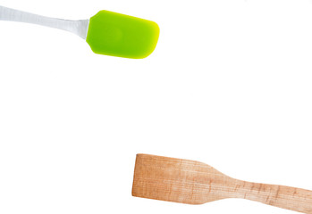 Silicone ans wooden spatulas for cooking on an isolated white background