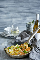 Pasta dish with grilled lemon chicken served with white wine