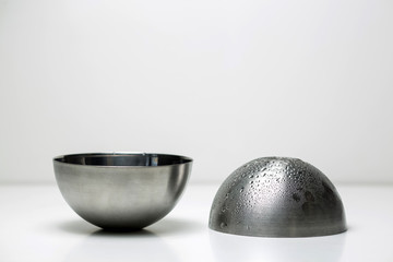 Stainless steel dishes for vegetables. White background