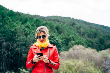 Woman with smartphone in the nature