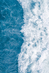 Fototapeta na wymiar Pale blue sea wave during high summer tide, abstract ocean background