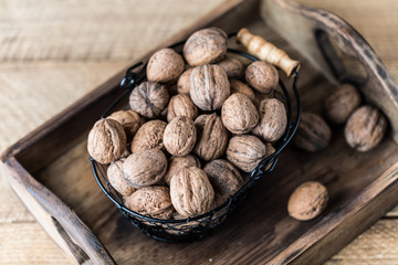 Walnuts on rustic wooden background. Food, nuts background. Print for kitchen