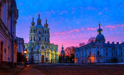 Obraz premium pink winter dawn with beautiful clouds over Smolny Cathedral and the Palace around. Saint Petersburg, Russia