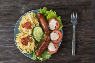 Pasta, vegetables and fried sausages