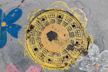 Colorful sewer hatch cover on the road