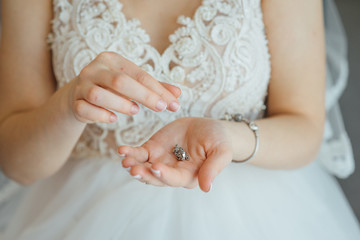 beautiful bride holding a necklace in her hands