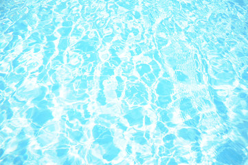 Pattern with blue water in the sunlight in the pool
