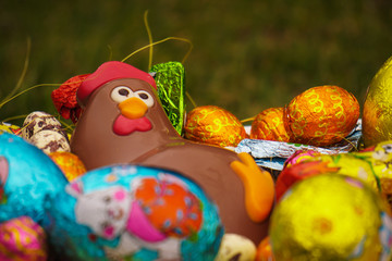 Fototapeta na wymiar Chocolate easter chicken in basket with chocolate eggs