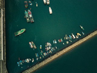 Fototapeta na wymiar Panoramic view from above of Small fishing boats near the wave barrier in aberdeen Typhoon Shelters Hong Kong