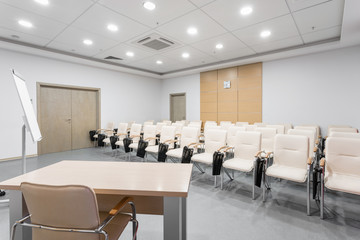 Fototapeta na wymiar Empty modern conference hall in new hotel. Room for training, education, group classes, exams. Audience for Speakers at Business convention and Presentation.