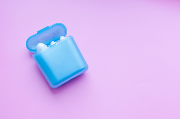blue box with tampons for female menstruation on a pink isolated background