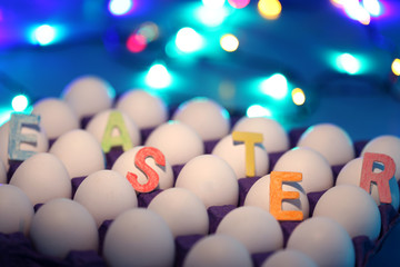 Easter background with Easter eggs and bokeh effect. Top view with copy space.