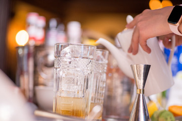 female bartender preparing cocktail in a cocktail bar