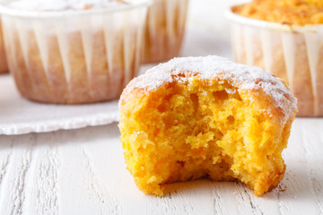 sweet pumpkin muffins with walnuts and powdered sugar