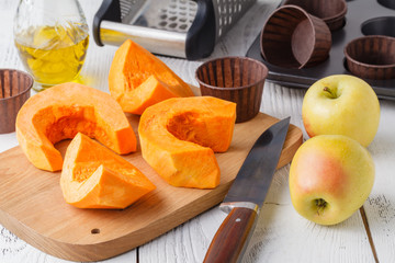 Naklejka na ściany i meble Fresh orange pumpkin, sliced and grated, prepare for cooking. Organic, seasonal, natural and healthy food concept