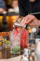 female bartender preparing cocktail in a cocktail bar