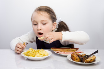 Girl sits at the table and going to drink tablets. Headache. hangover, bad state of health, insomnia. holding hands behind his head