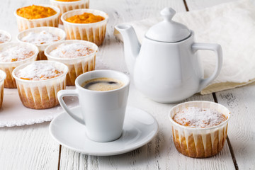 Obraz na płótnie Canvas sweet pumpkin muffins with walnuts and powdered sugar