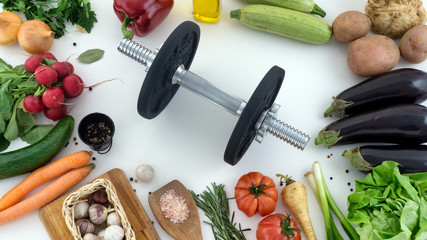 Top view of vegetables and a dumbbell healthy eating concept  - obrazy, fototapety, plakaty