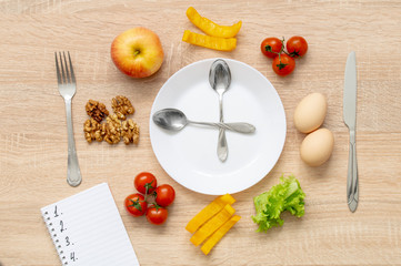 clock fruit plate, cherry Apple salad yellow pepper slices, walnuts, two boiled eggs and a Notepad...