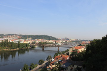 Fototapeta na wymiar Panoramic view of Prague and the railway bridge over the Vltava river in the Czech Republic