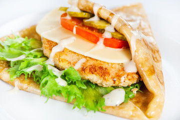 Thin delicious pancake with meat steak, cheese, tomato and greenery on white