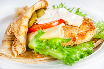 Thin delicious pancake with meat steak, cheese, tomato and greenery on white
