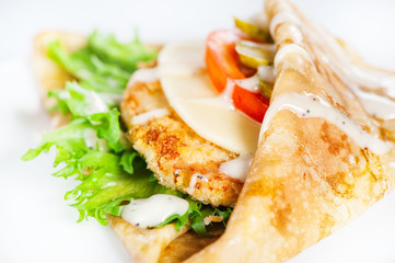 Thin delicious pancake with meat steak, cheese, tomato and greenery on white