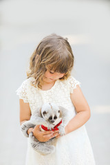 Making photo of exotic animals. Little girl with lory lemur