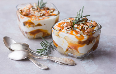 Dessert bowl with tasty caramel parfait on table.