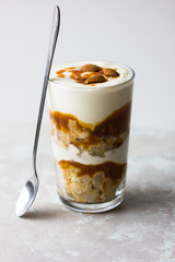 Dessert bowl with tasty caramel parfait on table.