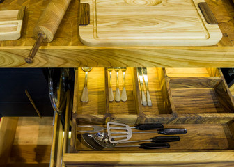 Wooden kitchen table with drawer for tableware with built-in lighting