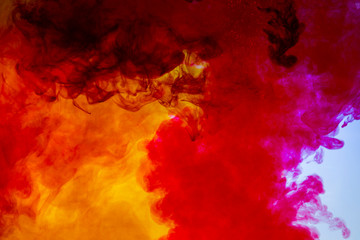 colorful paints dissolve in water, abstract background