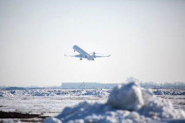 Passenger plane at airport in winter afternoon. plane on airport platform in  winter. Airplane on...