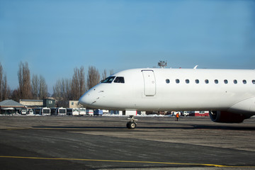 Passenger plane at airport in winter afternoon. plane on airport platform in  winter. Airplane on summer strip in winter