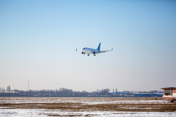 Passenger plane at airport in winter afternoon. plane on airport platform in  winter. Airplane on summer strip in winter