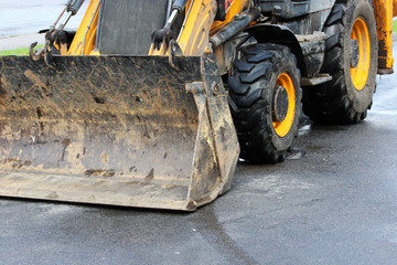 dozer blade of the tractor. Road repair extension in Gatchina, Russia. reportage.