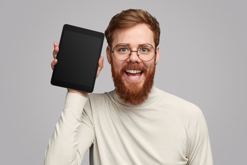 Ginger guy showing tablet
