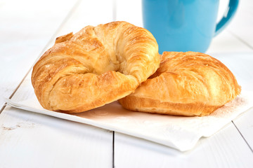 fresh baked croissants on wooden table