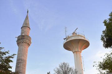 Military radar and mosque minaret silhouette.