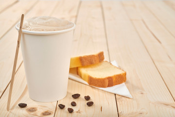 Coffee cup with pound cake on wooden table