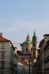 Fototapeta na wymiar View of the dome and bell tower of St. Nicholas Catholic Church in Prague