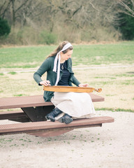 Girl Playing Dulcimer in a Park