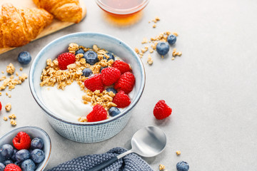 Yogurt with berries and granola in bowl