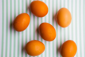 Farmer eggs on striped background.