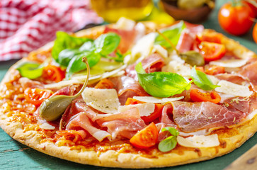 Appetizing italian pizza with prosciutto