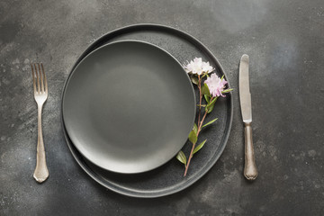 Easter table setting with spring flowers on dark. Top view.