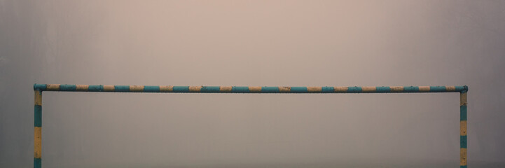 Metal frame for football goal in the fog.
