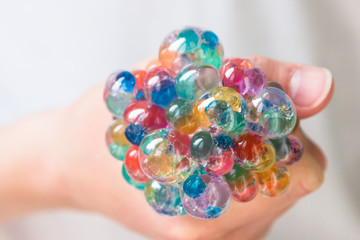 Children's and adult anti-stress toy to improve fine motor skills. Soft balls in the grid. Orbiz.
