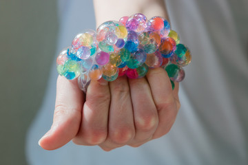 Children's and adult anti-stress toy to improve fine motor skills. Soft balls in the grid. Orbiz.